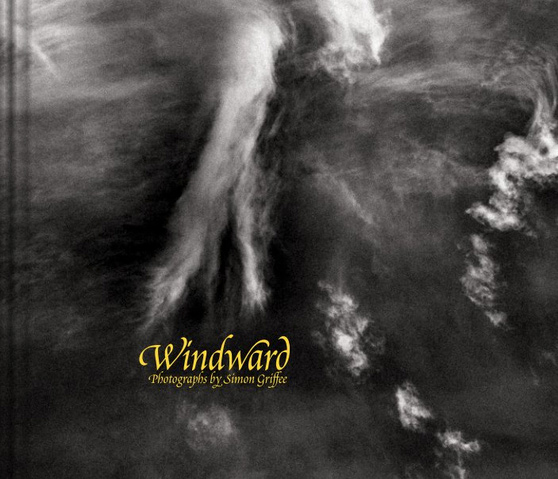 The cover of Windward shows the title in yellow text over a close-up of a black and white photograph of clouds.
