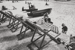 Sand, wind, chairs, children, adults, old woman, boats, beach, dad, mom.